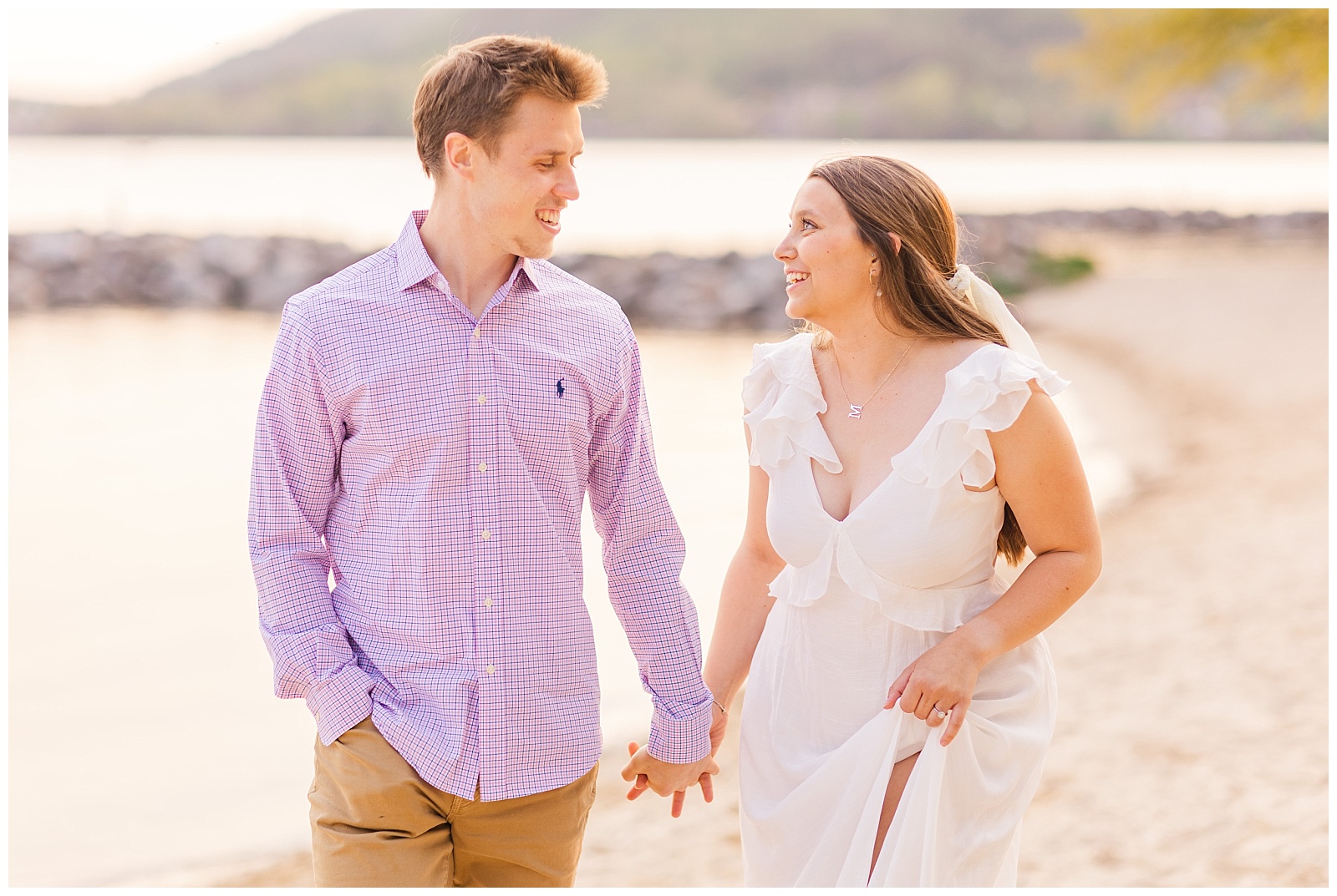 Couple walking along the beach at their Deep Creek Lake engagement session