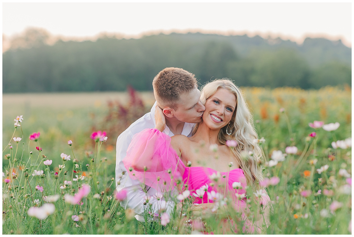 A romantic moment between a couple at their classic picnic engagement session in West Virginia