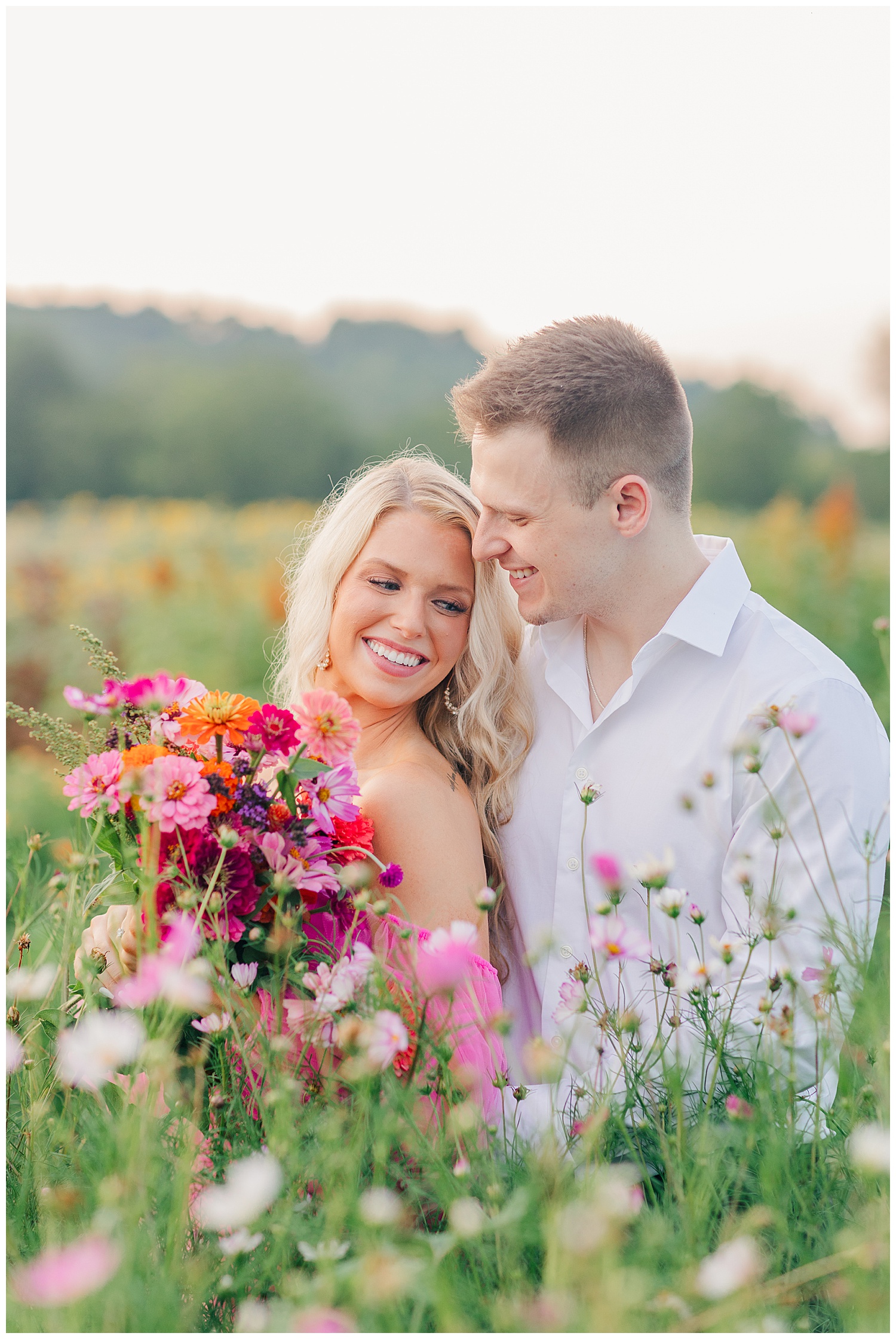 Laughter between a couple at their classic picnic engagement session in West Virginia