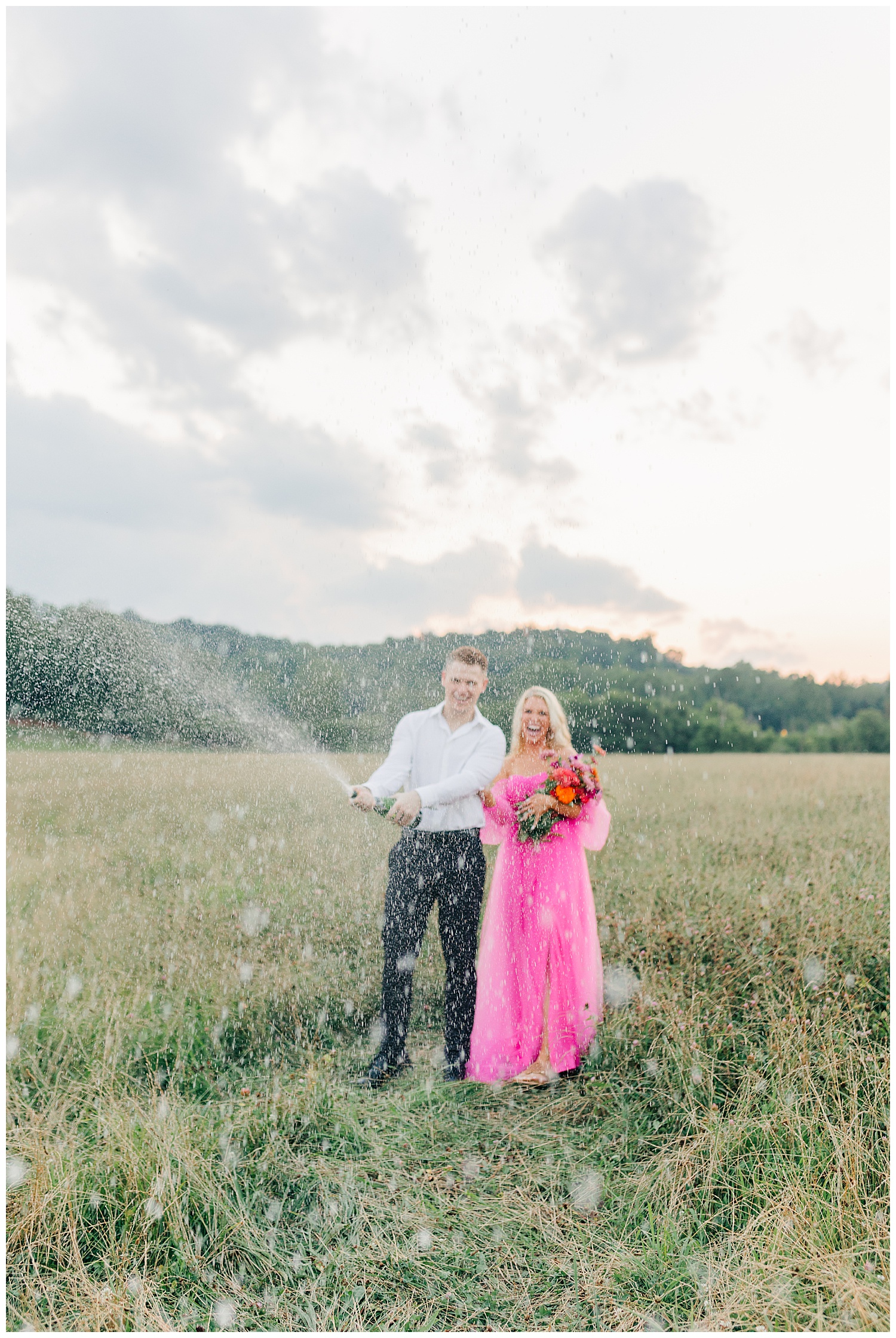 Abigail and Jace popping champagne at their classic picnic engagement session in West Virginia