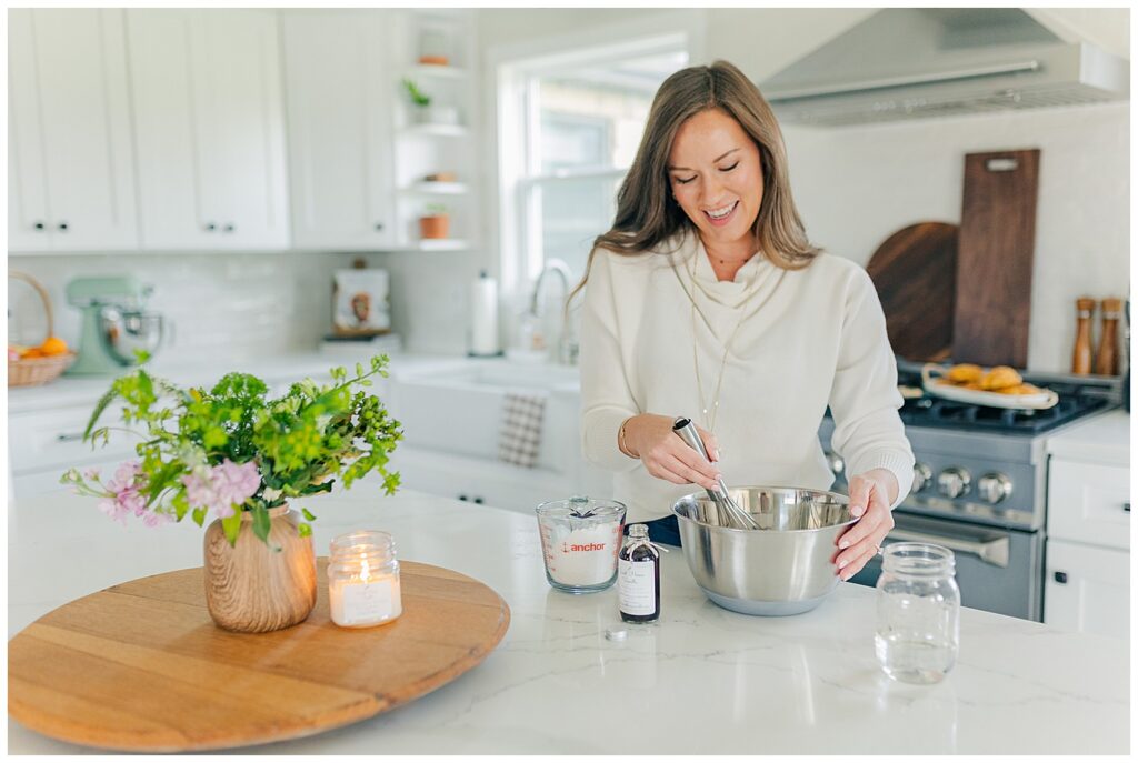Amanda carefully stirring vanilla beans and ingredients to prepare Sweet Home Vanilla extract kits during her Thomas, West Virginia branding session.