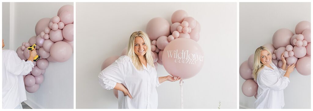 Morgan of Wildflower Events posing with a blush-toned balloon arch featuring her brand name, exuding a relaxed and playful vibe.