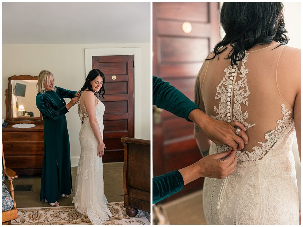 Bride smiling softly as her mother helps button up the back of her wedding gown before the ceremony.