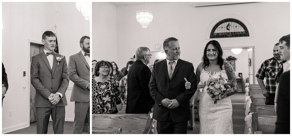 Black and white image of a proud father walking his daughter down the aisle as guests stand and watch during the ceremony.