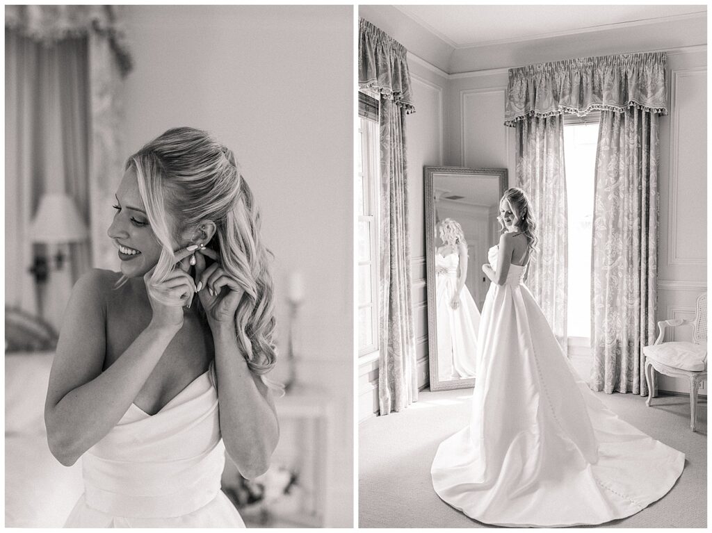 Bride puts on earrings with a smile while preparing for the wedding day, captured in soft black and white.