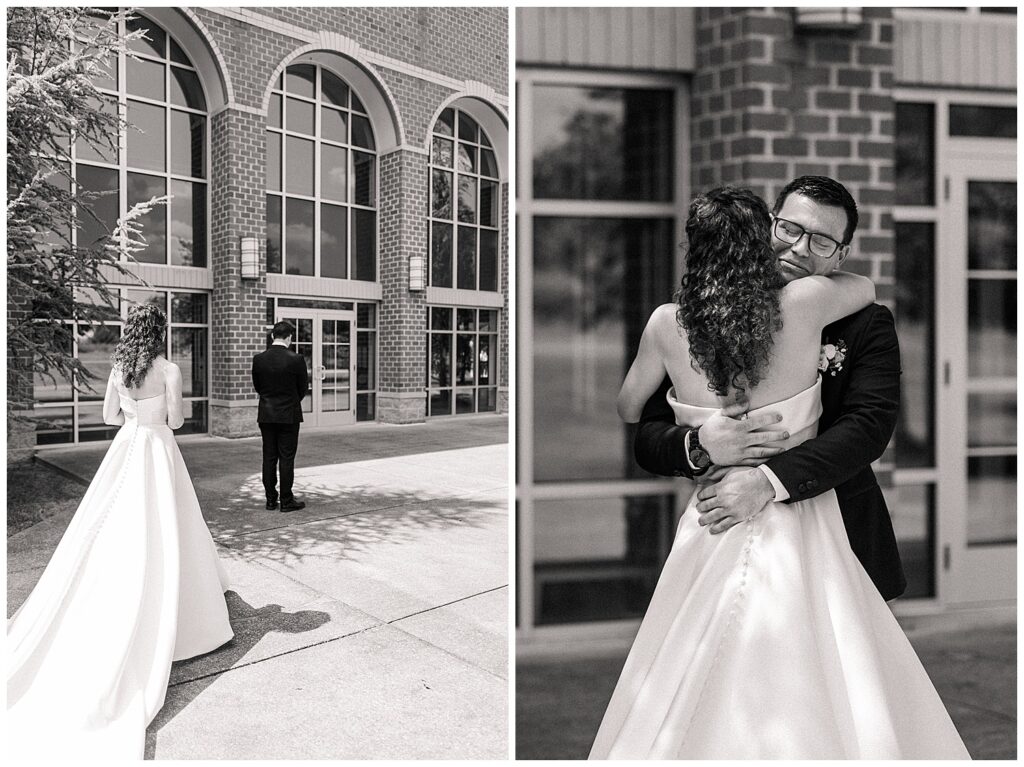 Black and white photo of bride walking toward groom for their first look outside Morgantown WV venue and Bride and groom embracing after emotional first look in front of brick building — Zoe Evans Photography