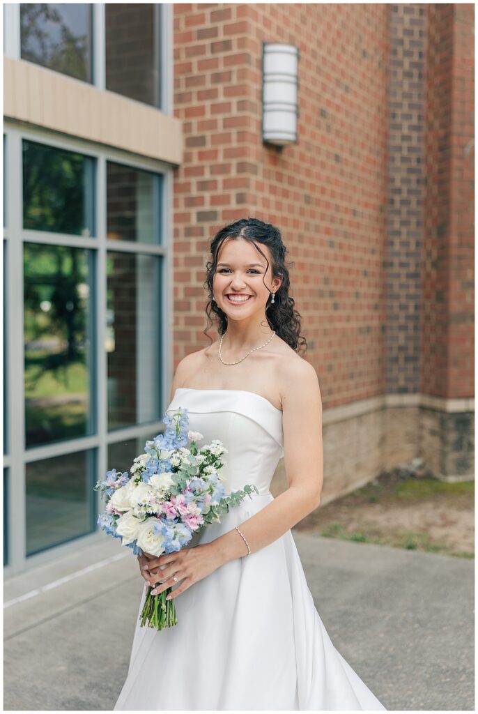 Close-up bridal portrait of Kaitlyn smiling and holding spring bouquet in Morgantown WV