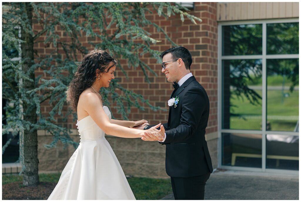 Bride and groom holding hands and smiling during their private vow exchange — Zoe Evans Photography