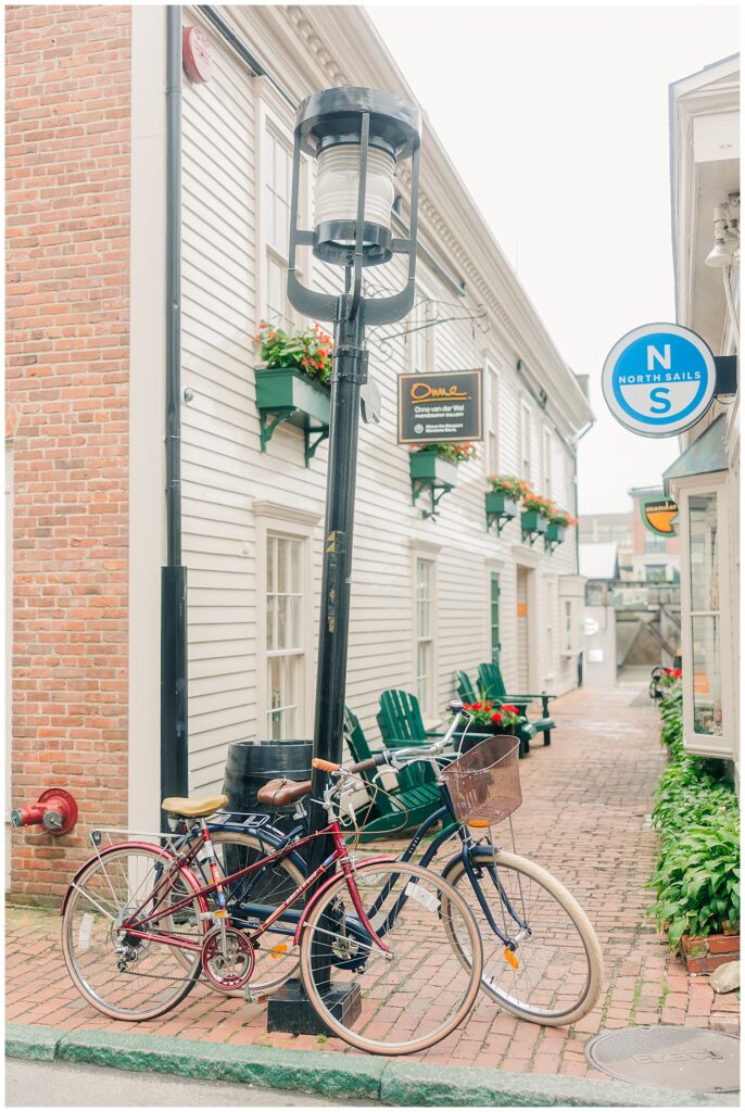 Street scene from Newport’s downtown featuring storefronts and seasonal decor, captured during a branding session for luxury travel planner Lauren. Photo by Zoe Evans Photography.
