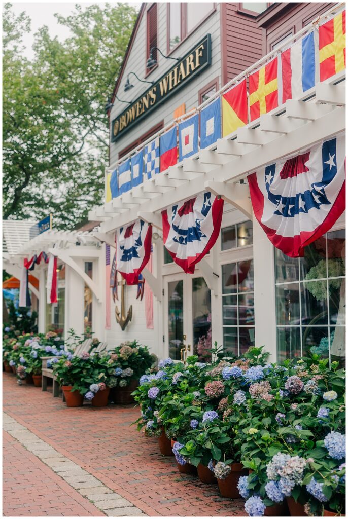 Lauren seated outside a nautical-themed shop in Newport, RI, a brand image designed to reflect her all-American coastal travel aesthetic. Shot by Zoe Evans Photography.