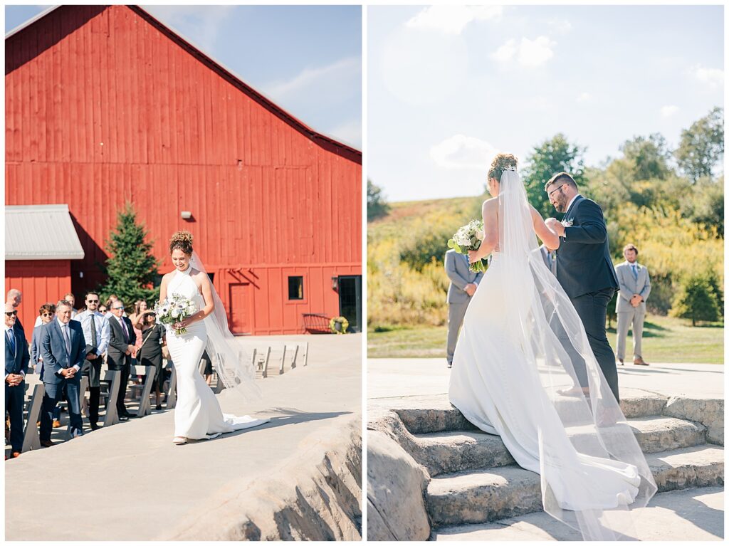 Outdoor wedding ceremony moment with bride and groom holding hands beneath a floral arch at Red Barn Inn