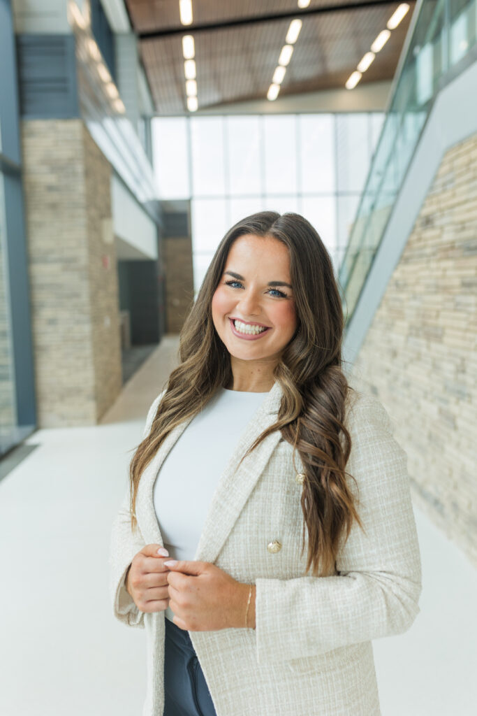 Smiling woman in a cream blazer during a personal brand photography session – captured by Zoe Evans Photography. Perfect for business owners updating their brand.