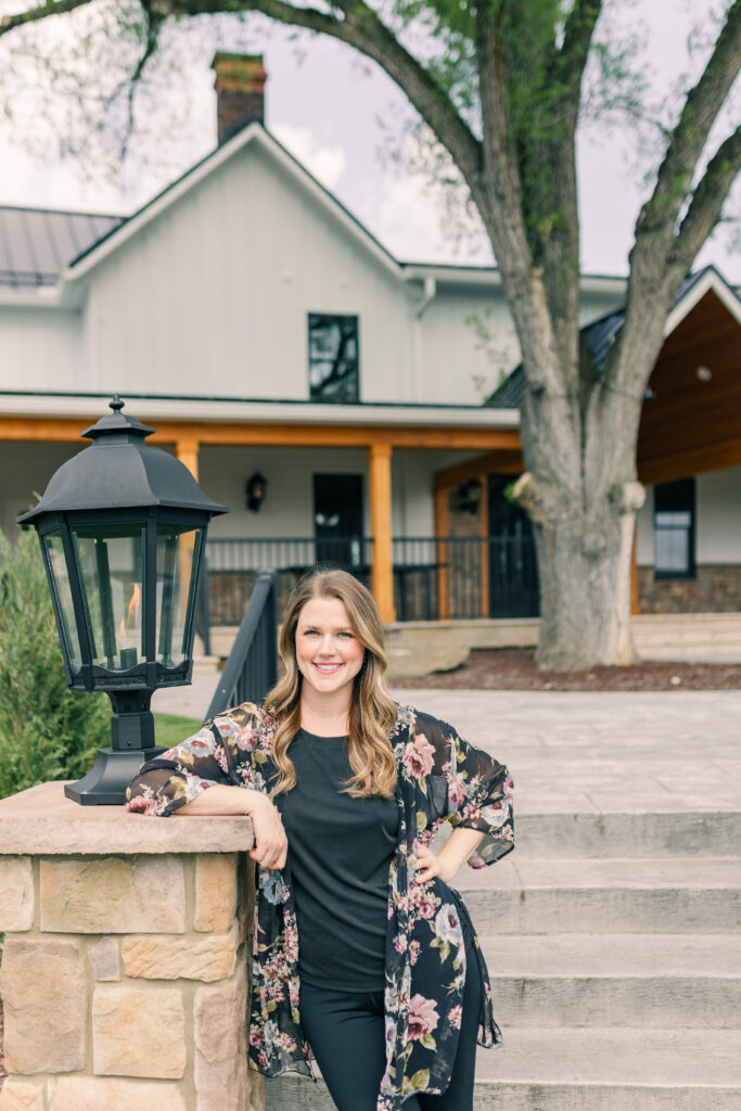 Female business owner posing confidently outside a professional venue – personal brand photography by Zoe Evans. Custom sessions now booking.