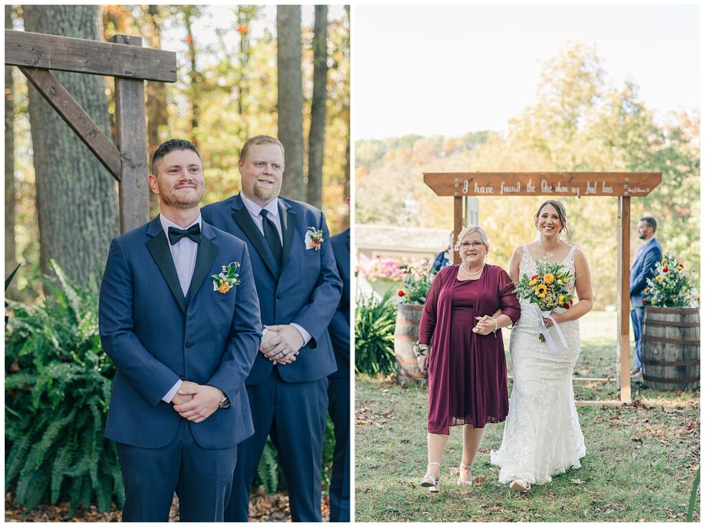 Groom smiles while standing with his groomsman, waiting at the altar under a wooden arbor framed by fall trees.