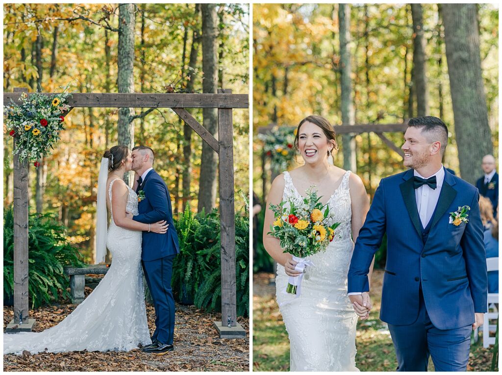 Bride and groom share their first kiss under a rustic wooden arbor surrounded by fall foliage during their outdoor ceremony.