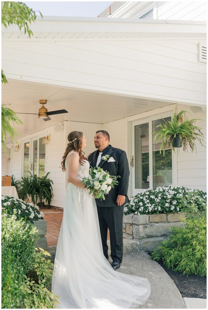 Bride and groom sharing a quiet moment on the front porch of Ellis House in Maryland, captured by Zoe Evans Photography.