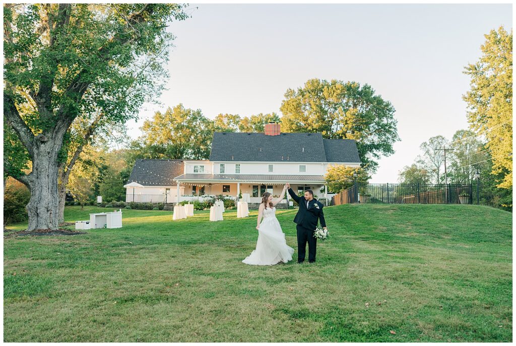 Bride and groom walking across the Ellis House lawn during golden hour portraits, photographed by Zoe Evans Photography.