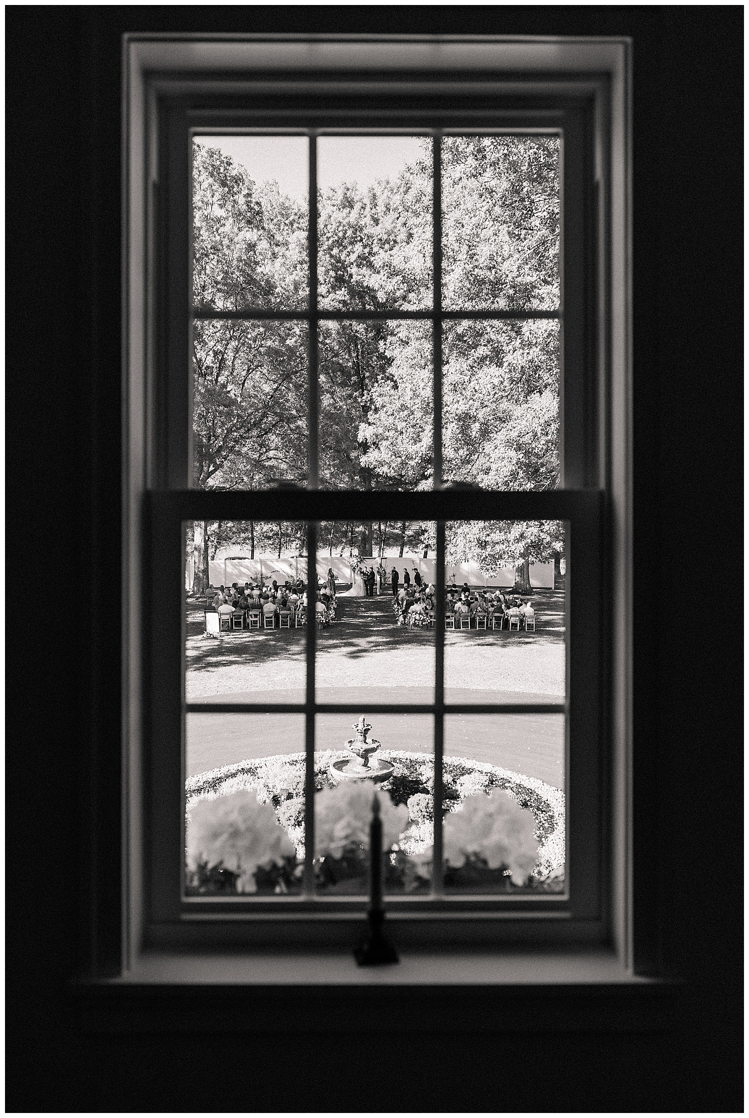 Black and white image of the Ellis House wedding ceremony chairs reflected in the window, captured by Zoe Evans Photography.