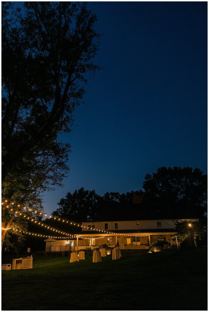 Evening view of Ellis House Maryland wedding venue with romantic string lights, beautifully captured by Zoe Evans Photography.