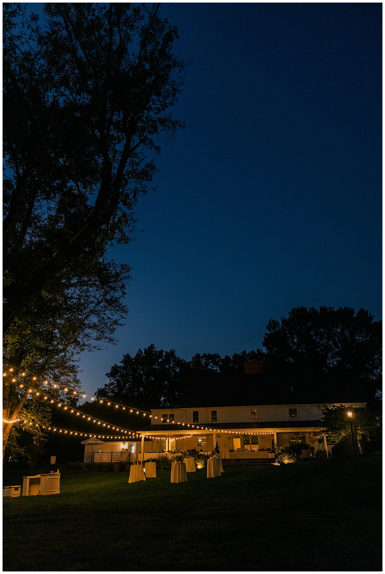 Evening view of Ellis House Fairmont West Virginia wedding venue with romantic string lights, beautifully captured by Zoe Evans Photography.