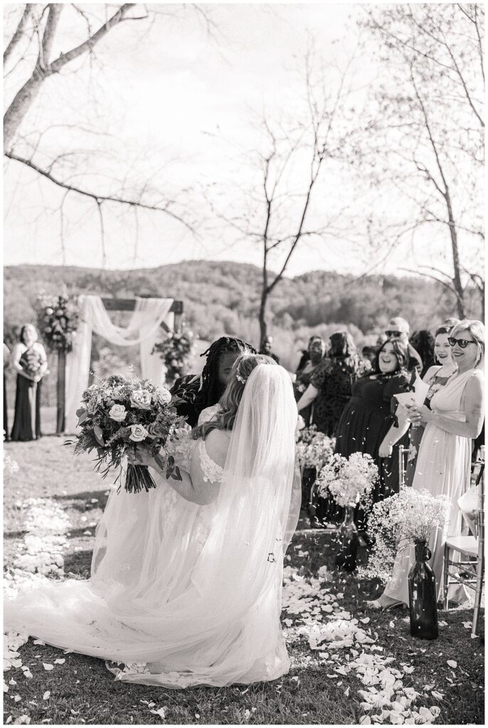 Black and white photo of the bride walking down the aisle at Palomino Pastures outdoor ceremony in the hills of West Virginia.