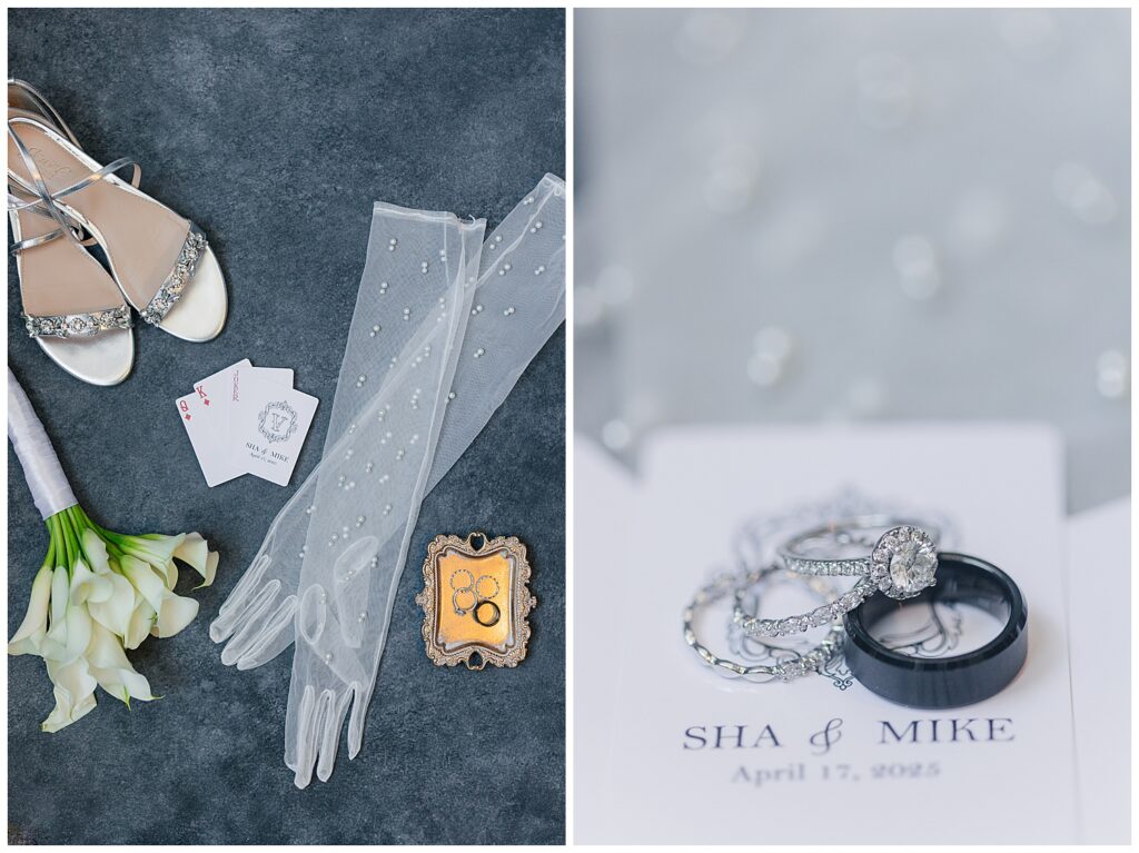 Flat lay of wedding gloves, rings, and invitation suite on a soft blue backdrop.