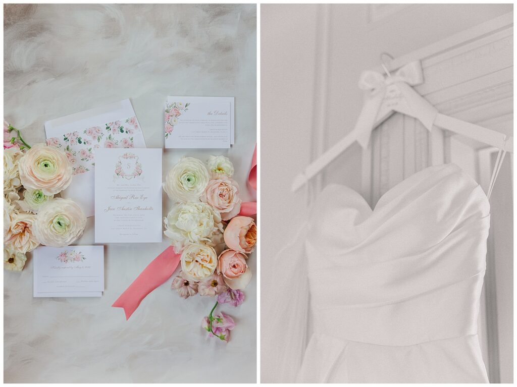 Delicate flat lay of pastel floral stationery, heirloom ring box, and wedding dress hanging at Great Marsh Estate.