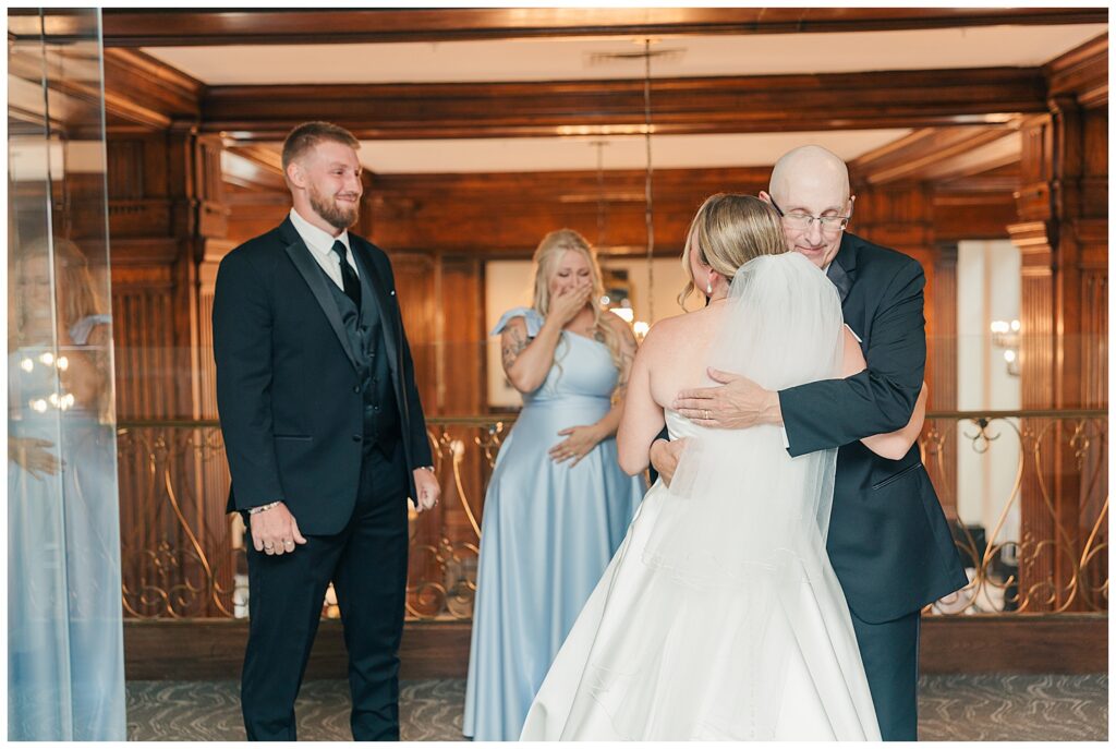 Emotional embrace between bride and family members during wedding day moments inside Hotel Morgan.
