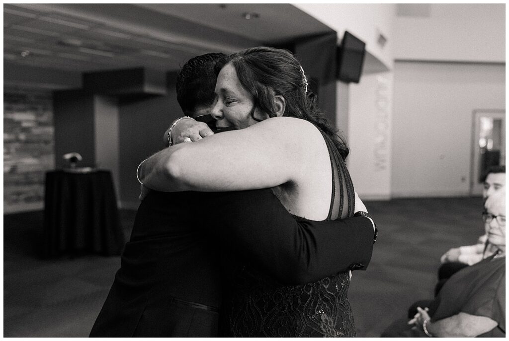 Emotional moment of bride hugging a loved one during wedding day celebrations in Morgantown, WV