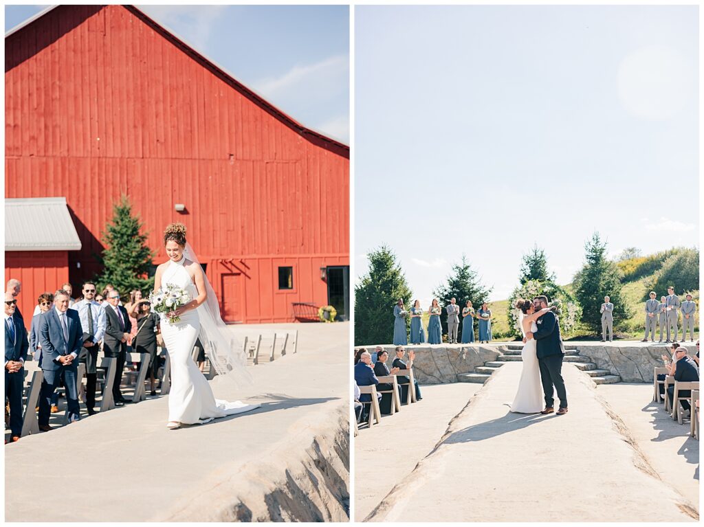 Bride walking down the aisle during outdoor ceremony with red barn backdrop at the Red Barn Inn