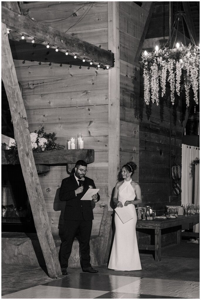 Bride and groom giving heartfelt speeches during wedding reception at the Red Barn Inn