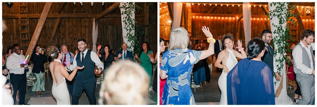 Guests dancing and celebrating during the wedding reception inside the Red Barn Inn’s rustic barn