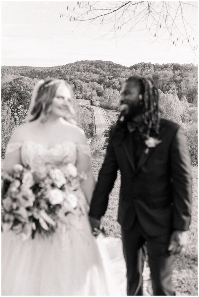 Candid moment of bride and groom sharing a joyful glance at their fall wedding in the scenic mountains of Palomino Pastures.