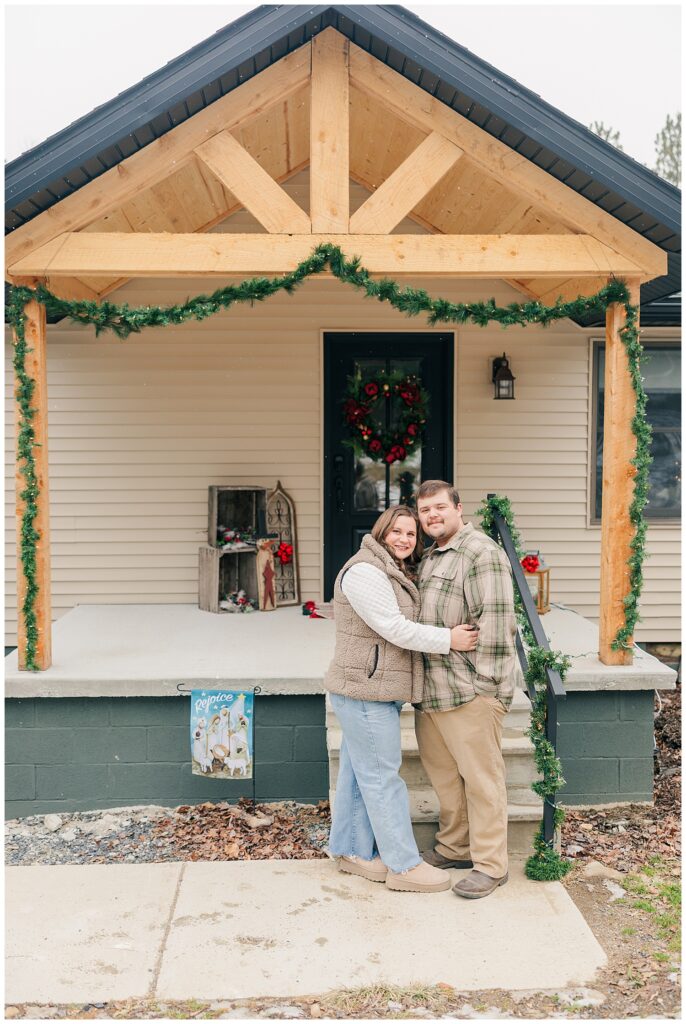 Couple standing on a decorated front porch during a cozy lifestyle photoshoot. West Virginia Photographer