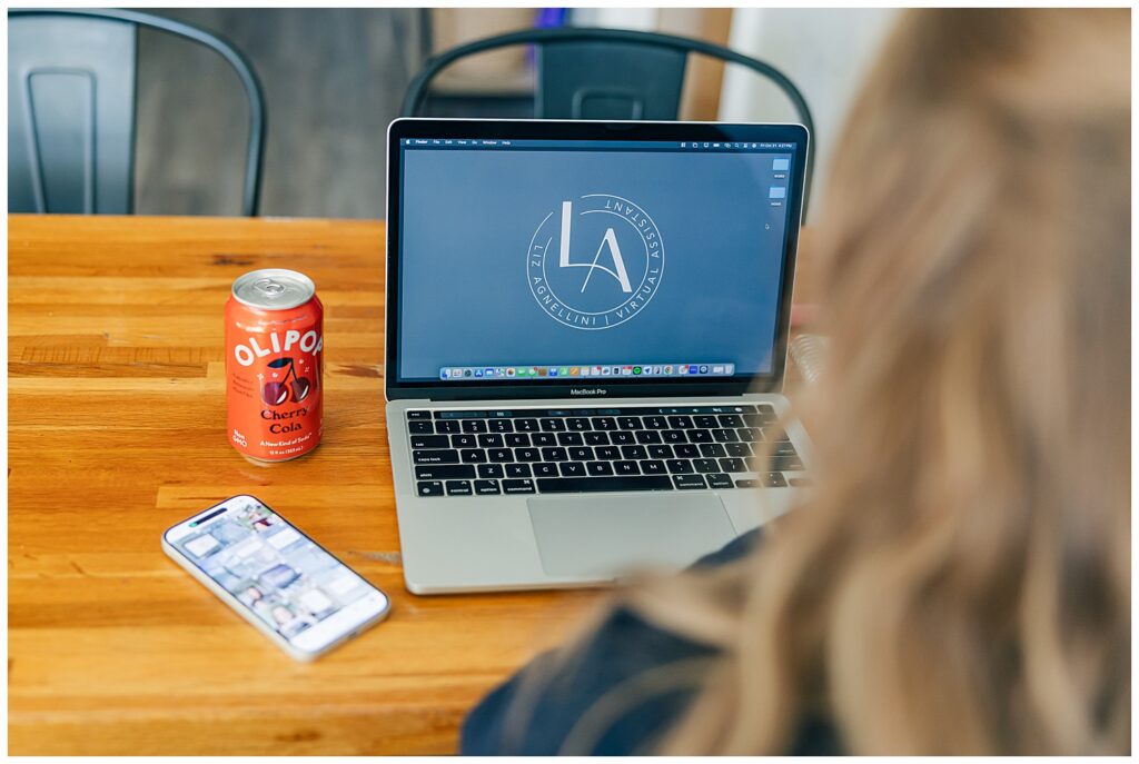 Detail shot of a Strawberry Vanilla Olipop can and iPhone next to a laptop, creating lifestyle branding content with intentional product styling.