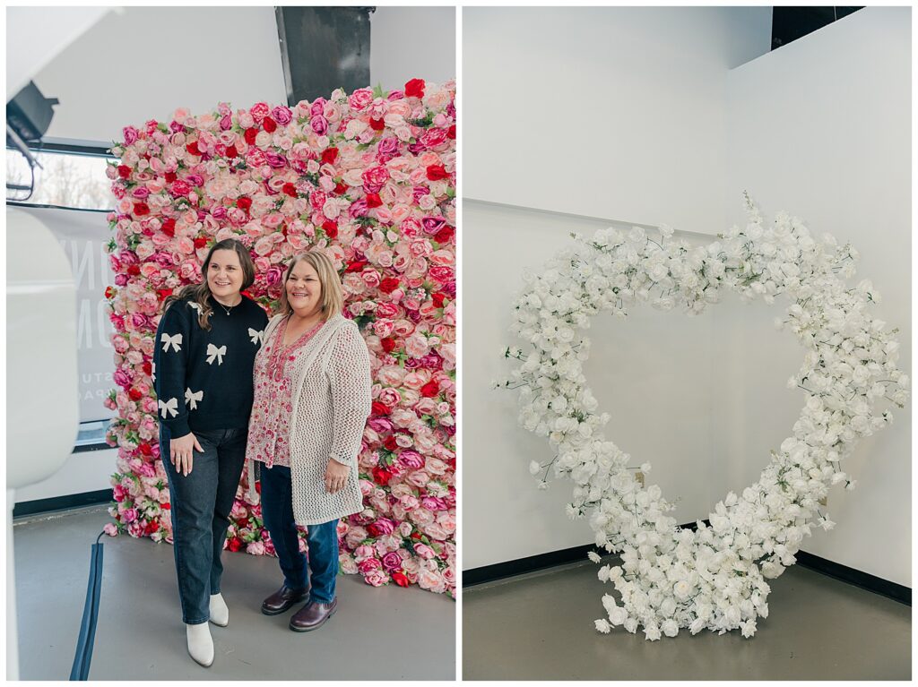 Two female entrepreneurs posing in front of a pink floral backdrop at a branding event for small business owners.