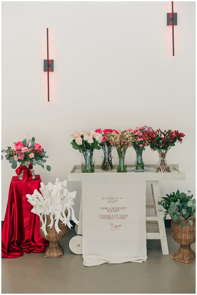 Styled floral display and welcome signage at a branding event for small business owners, featuring intentional decor and brand-focused details.