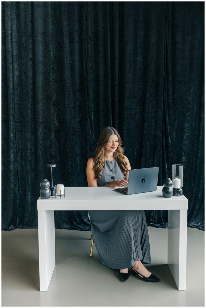 Lifestyle branding image of a Brittany Ann’s Events team member working at a desk during a professional session at The Onyx Room West Virginia