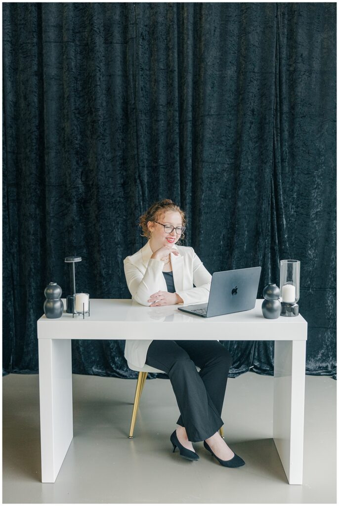 Behind-the-scenes branding photo of a Brittany Ann’s Events team member working on a laptop at The Onyx Room West Virginia studio