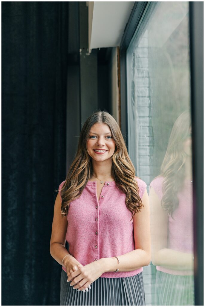 Bright natural light branding headshot of a Brittany Ann’s Events team member near a window at The Onyx Room West Virginia in Morgantown WV