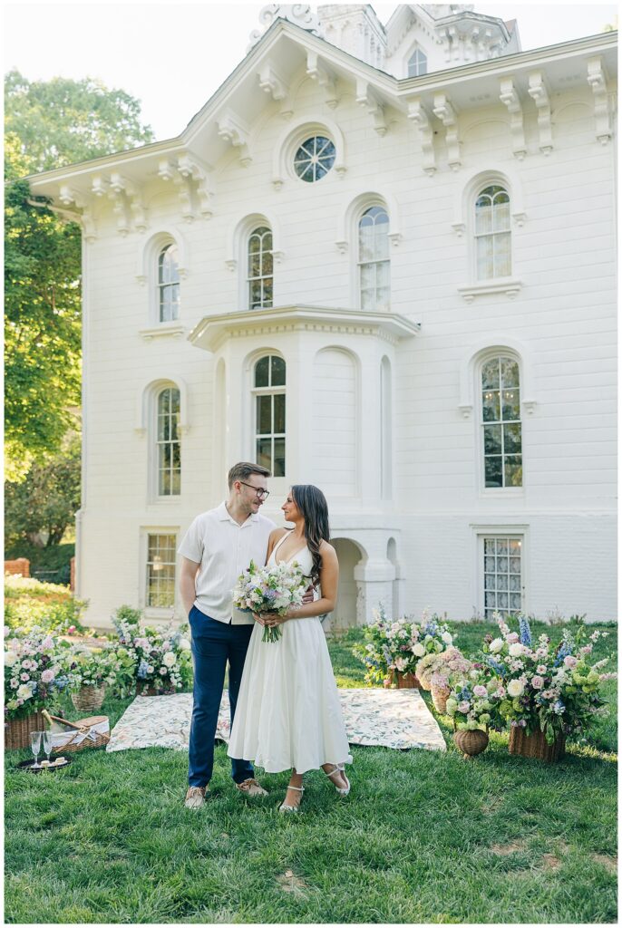 Outdoor engagement photos at Mayhurst Estate with luxury picnic styling, colorful blooms, and romantic estate wedding inspiration in Virginia.