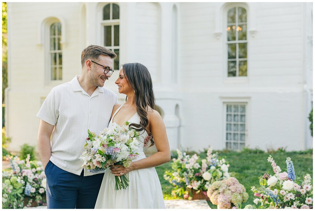 Engaged couple sharing a romantic moment outside Mayhurst Estate in Virginia during a luxury garden-inspired engagement session with floral styling and soft golden hour light.