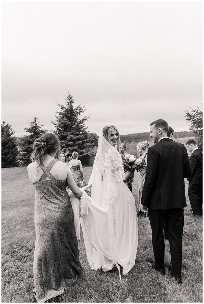 Faith and Luke exchanging vows during their outdoor Red Barn Inn wedding ceremony, captured by luxury photographer Zoe Evans Photography.