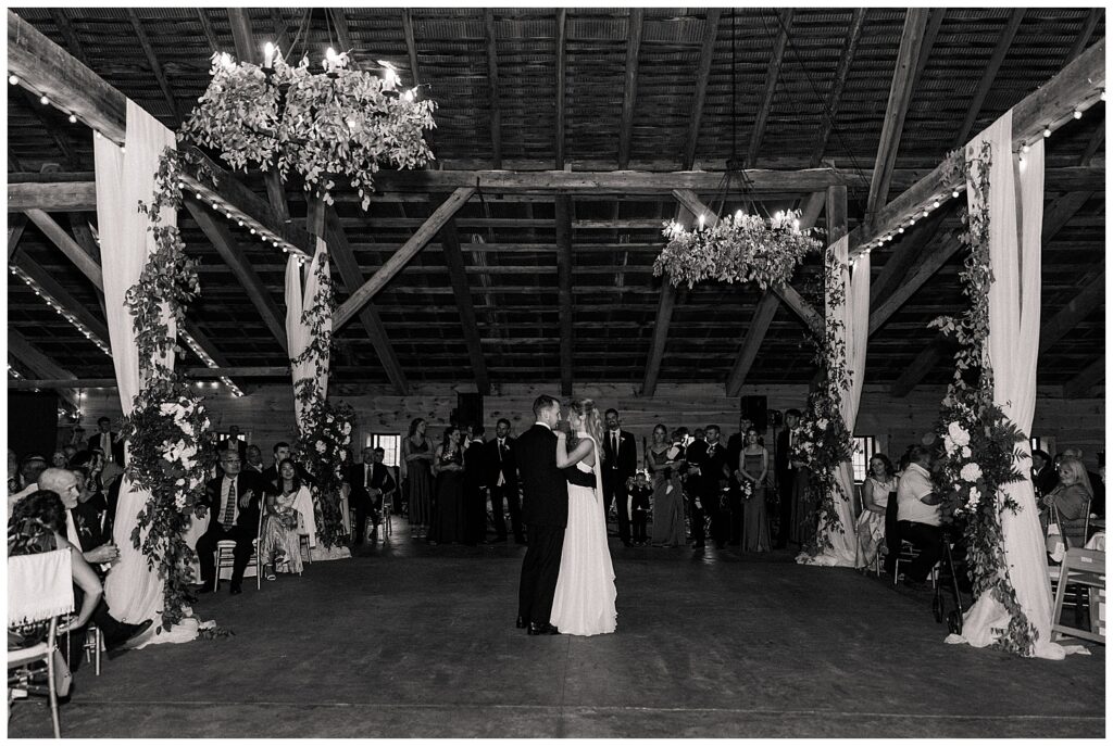 Black-and-white view of Faith and Luke’s elegant outdoor ceremony at the Red Barn Inn, photographed by Zoe Evans Photography.